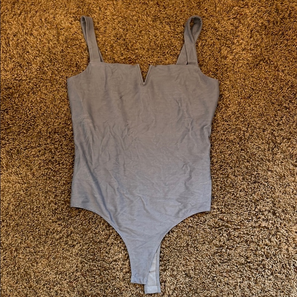 Woman’s blue bodysuit